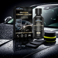 Rayhong Graphene Ceramic Coating kit displayed on a wet car hood, including the black product box, a black bottle, two applicator cloths, and a sponge, with a blurred car background.